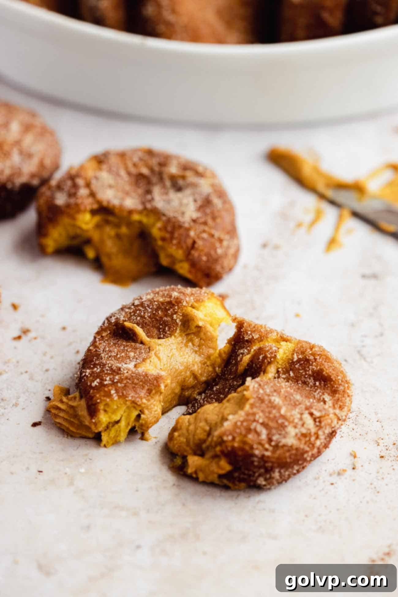 torn apart pumpkin spice donut with filling coming out