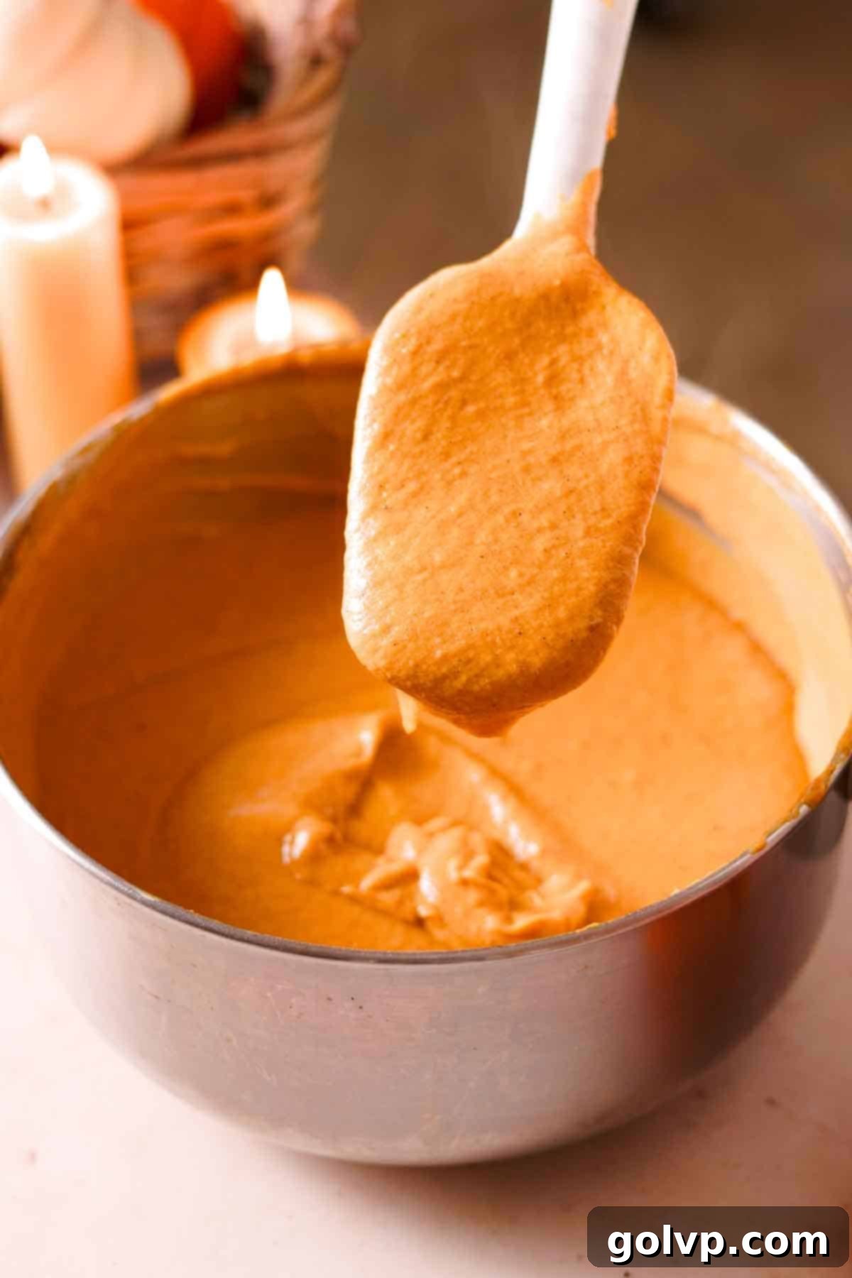 showing the thickened consistency of pumpkin custard on a rubber spatula