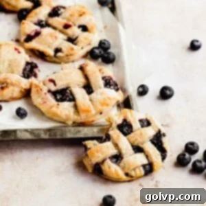 mini blueberry pies with lattice crust on baking tray