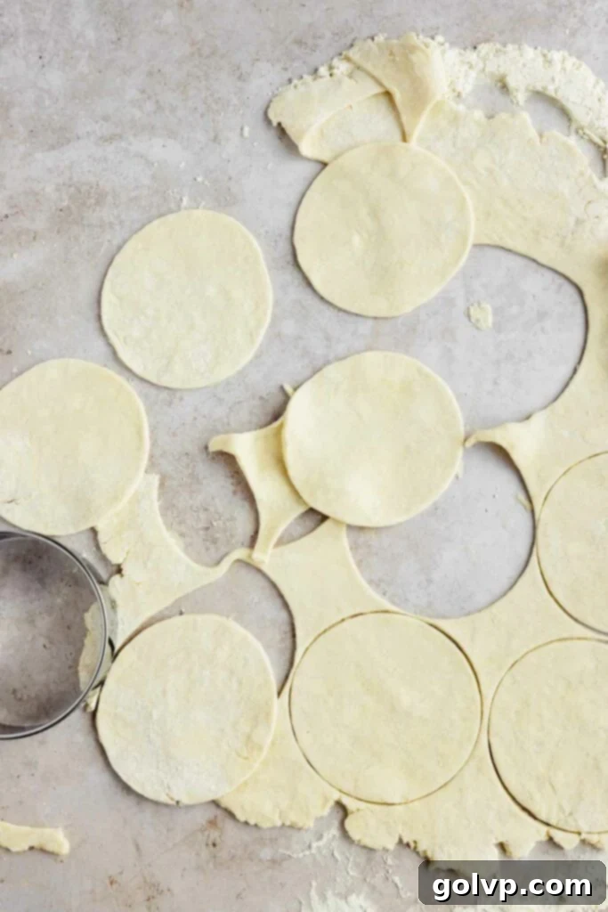 Cutting out circles of pie dough for the bottom crust of mini pies.