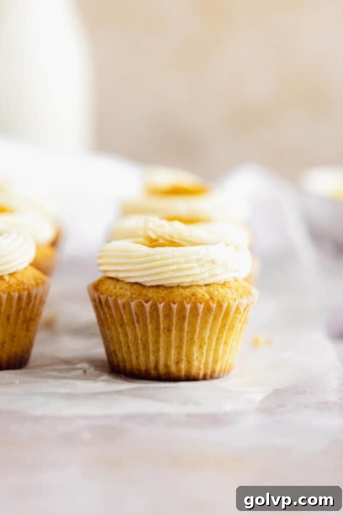 Beautifully frosted and decorated mango cupcakes, arranged for serving.