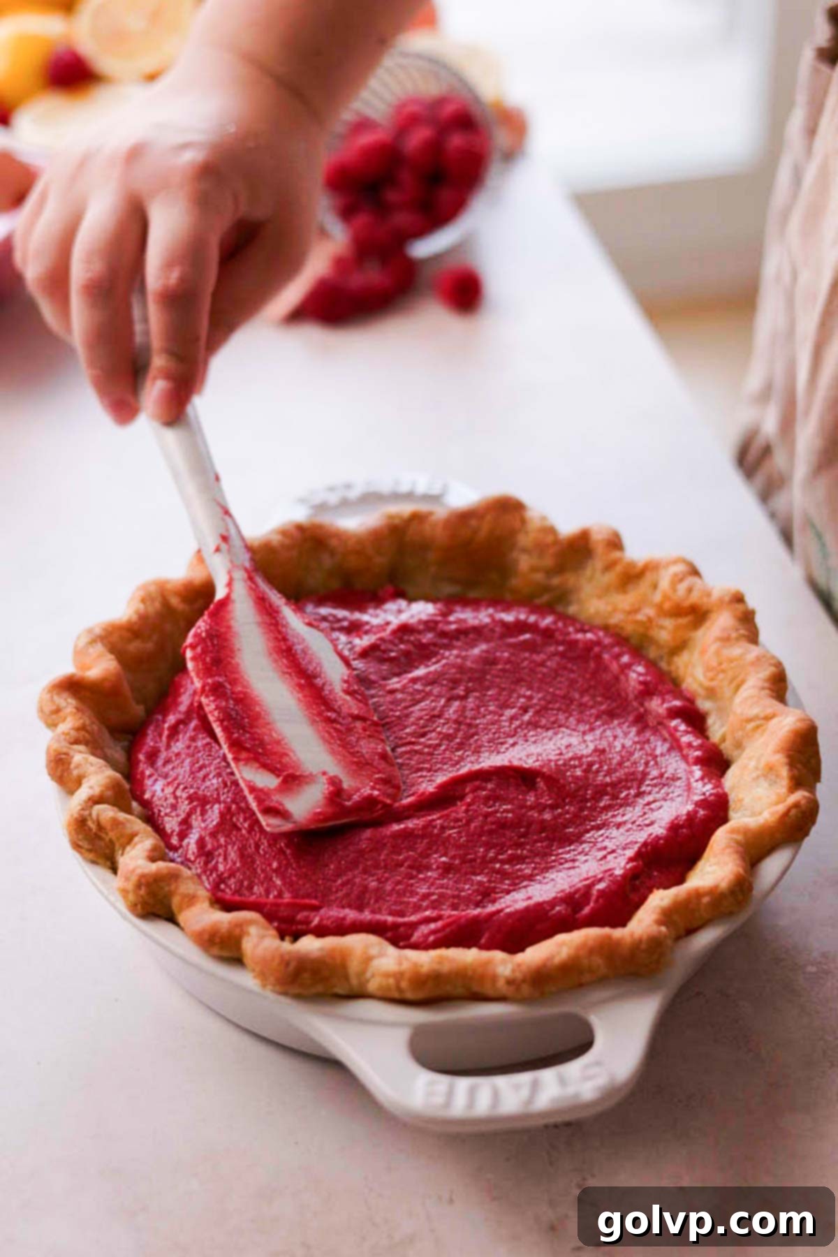 filling pie crust with raspberry filling