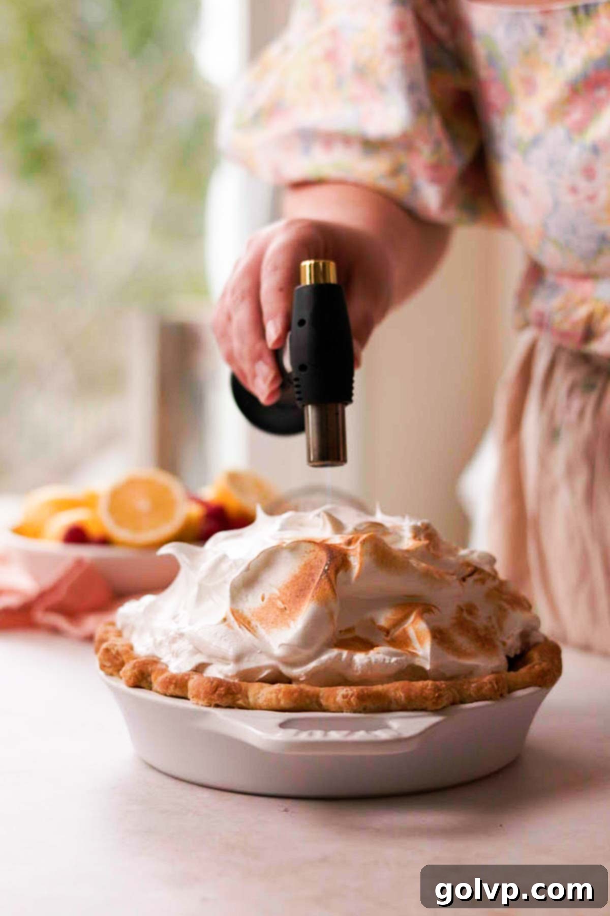 toasting the top of meringue with a kitchen torch
