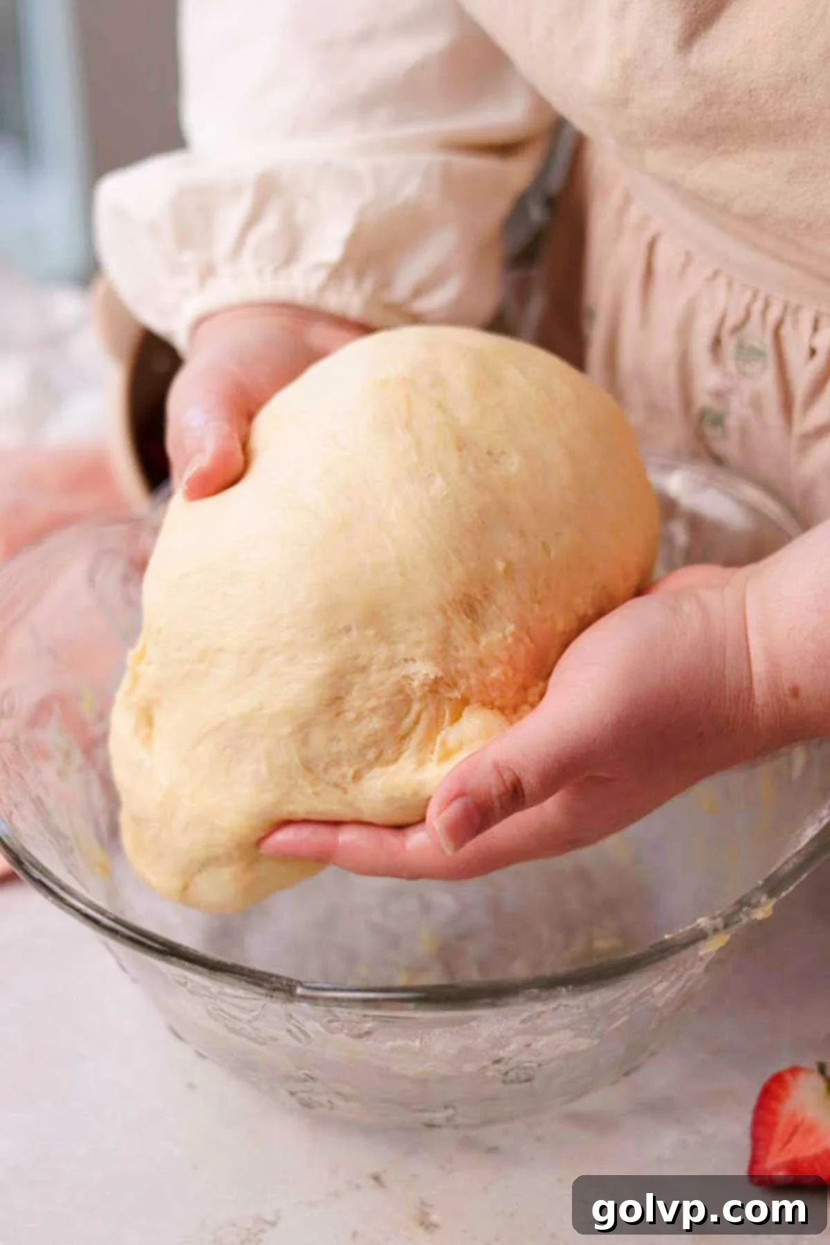 Fresh Strawberry Cinnamon Swirls 11 Gently mixing and folding the risen dough by hand on a floured surface to achieve a smooth consistency.