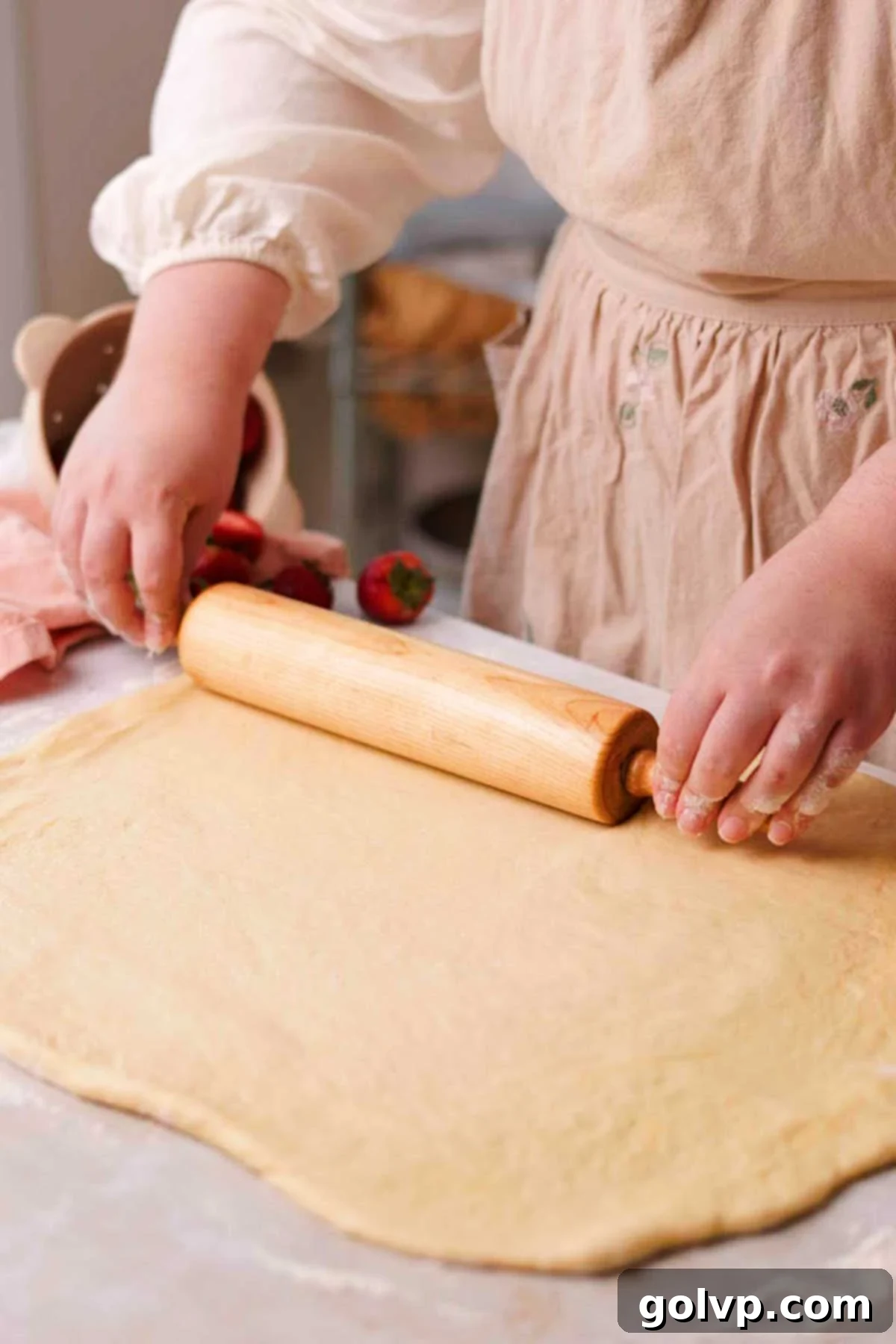 Fresh Strawberry Cinnamon Swirls 12 Rolling out the smooth dough into a large rectangle on a lightly floured surface using a wooden rolling pin.