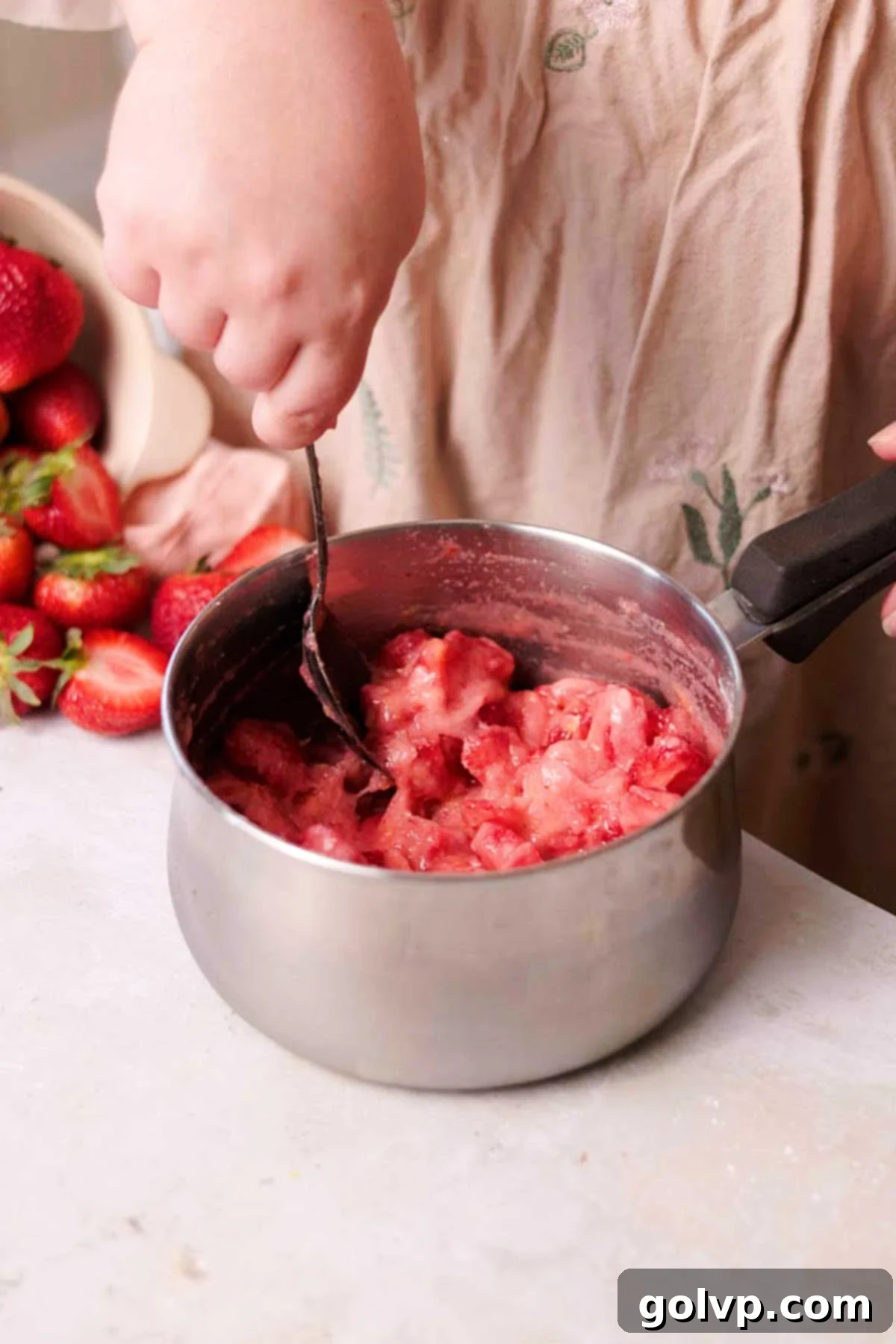 Fresh Strawberry Cinnamon Swirls 5 Stirring uncooked strawberry filling ingredients in a saucepan on the stove.