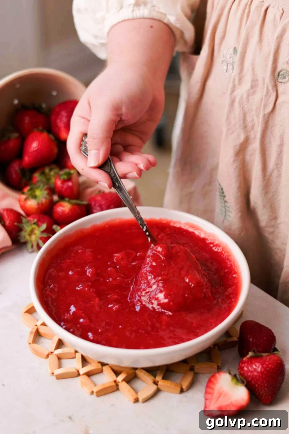 Fresh Strawberry Cinnamon Swirls 6 Cooked strawberry sauce with a rich, glossy texture in a white bowl.