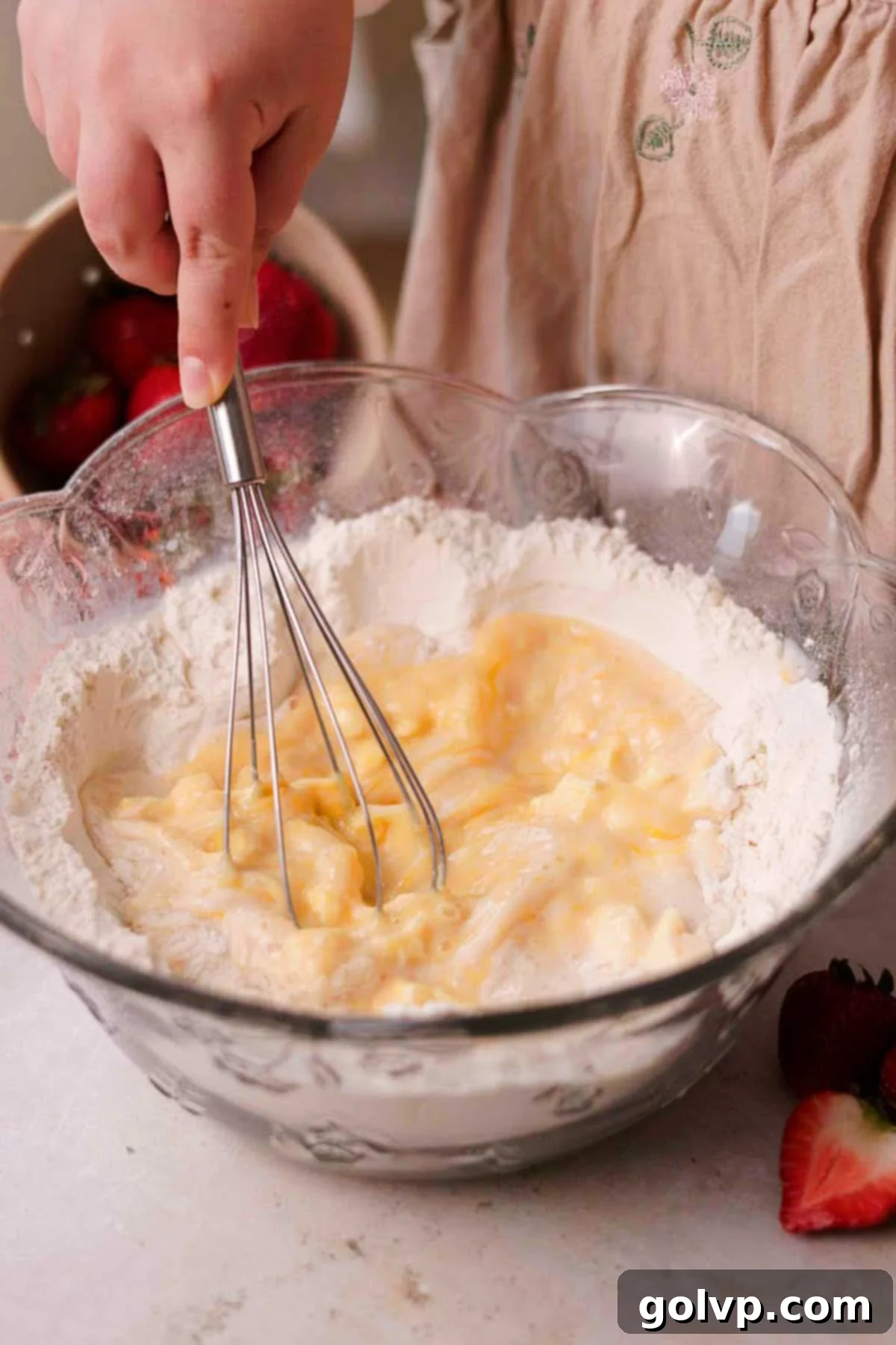 Fresh Strawberry Cinnamon Swirls 8 Whisking wet ingredients (butter, eggs, vanilla, milk, yeast mixture) in a flour well in a large glass bowl.