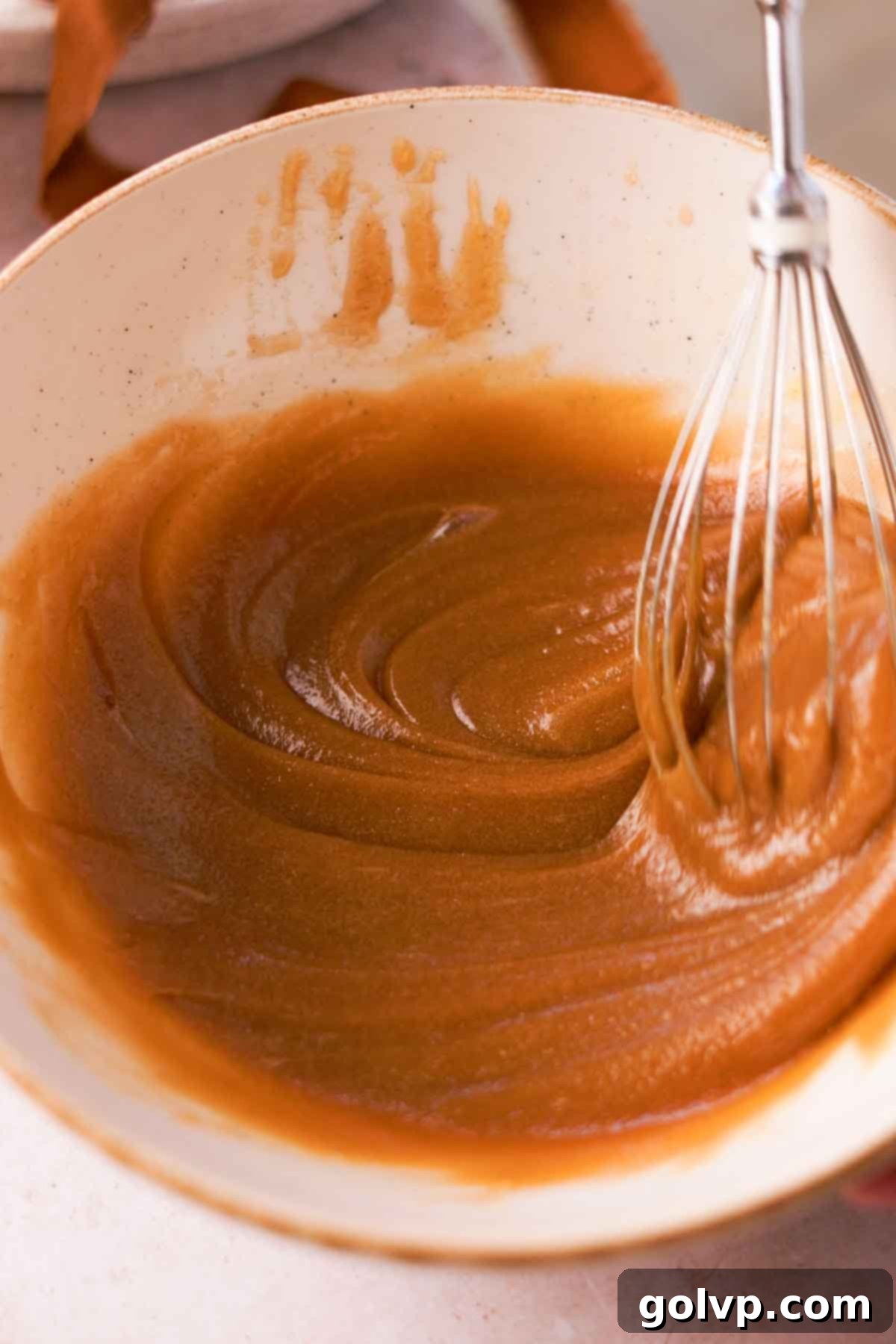 whisking melted butter, sugar, and egg mixture until thick and creamy