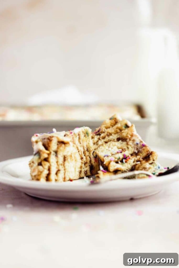 Cut open funfetti cinnamon roll on plate