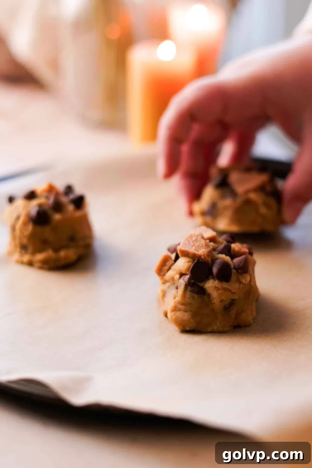 Heavenly Toffee Cookies: Our Foolproof Homemade Toffee Secret 18 placing cookie dough balls onto parchment lined baking sheet