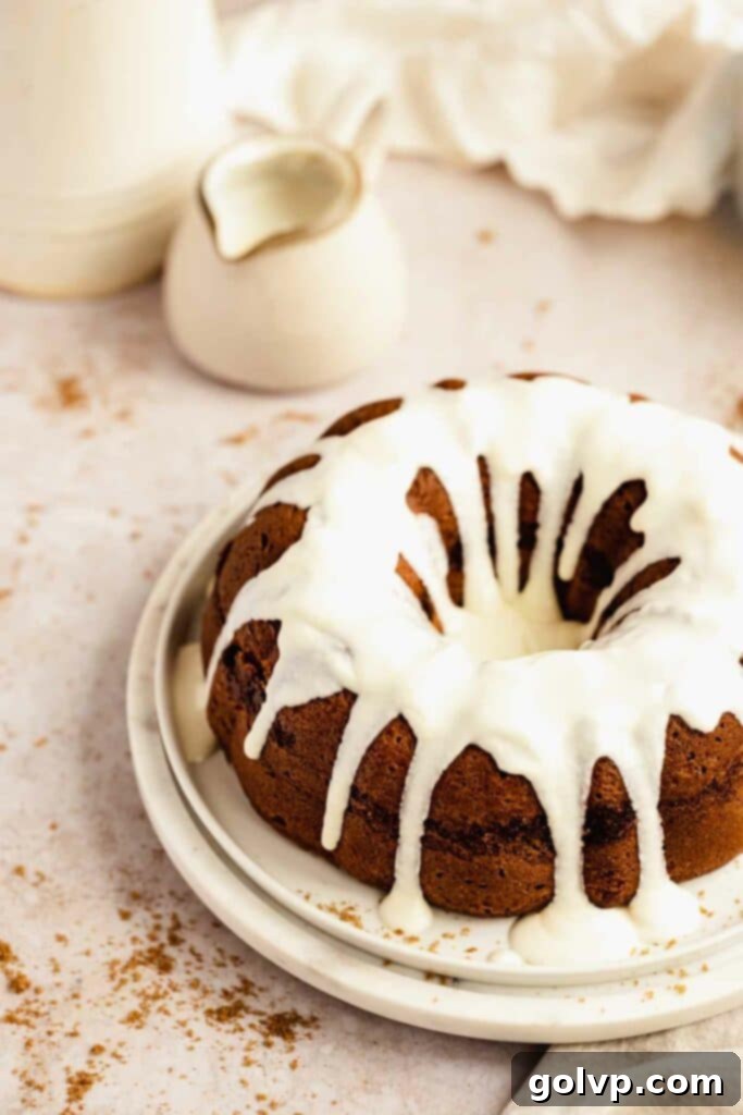 The glazed cinnamon bundt cake on cake plate