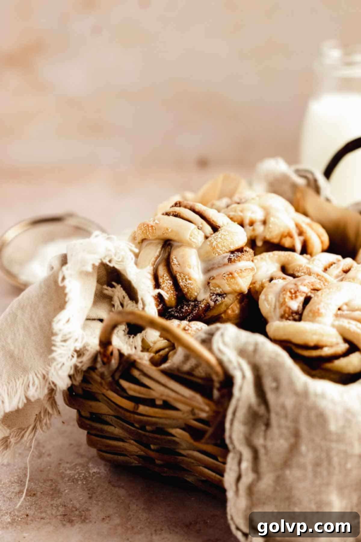 Cinnamon Swirl Delights 12 Basket of twisted cinnamon rolls, some dusted with icing sugar