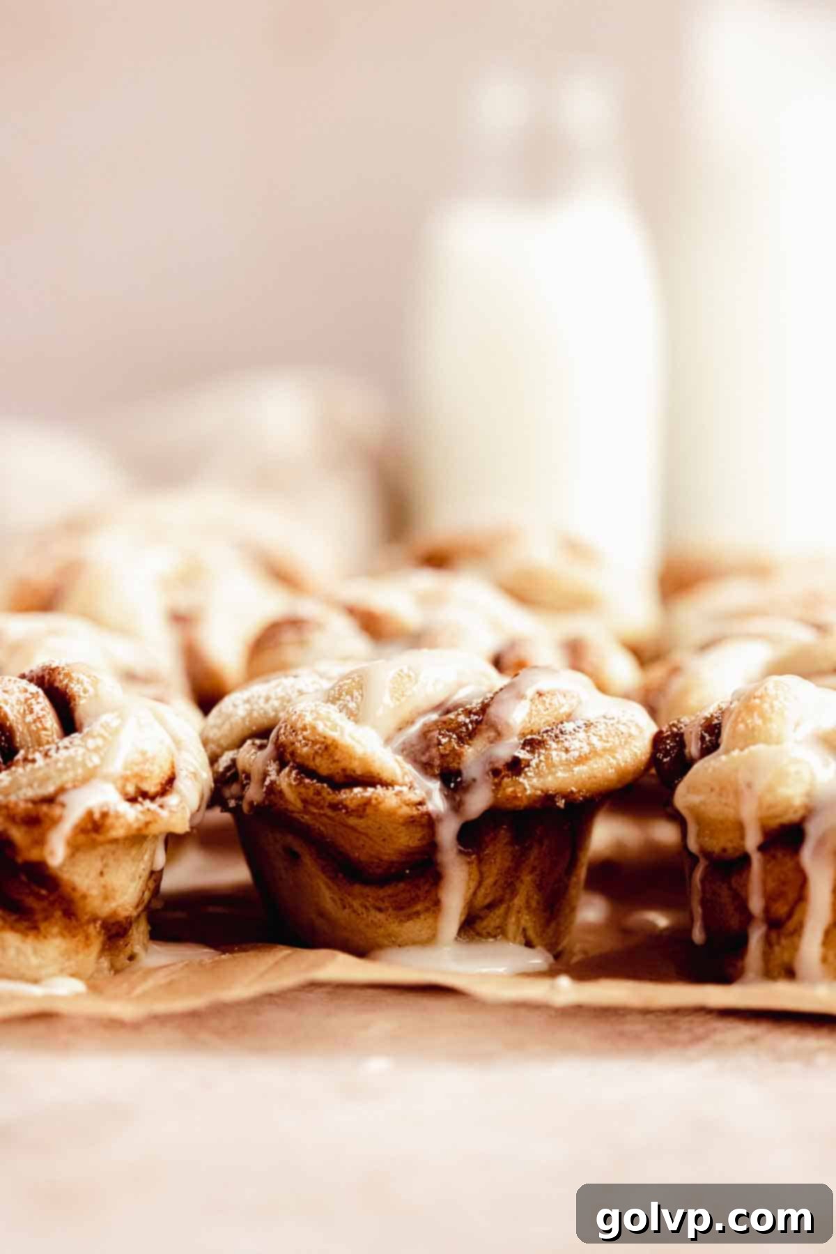 Cinnamon Swirl Delights 13 Close-up of a warm, drizzled twisted cinnamon roll, showcasing its gooey texture