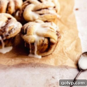 Cinnamon Swirl Delights 14 Cinnamon roll muffins on parchment paper with a spoon, ready to be served
