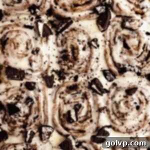 Decadent No-Knead Cookies and Cream Cinnamon Rolls 10 Overhead shot of Cookies and Cream Cinnamon Rolls topped with cream cheese frosting and crushed Oreos in a baking dish.