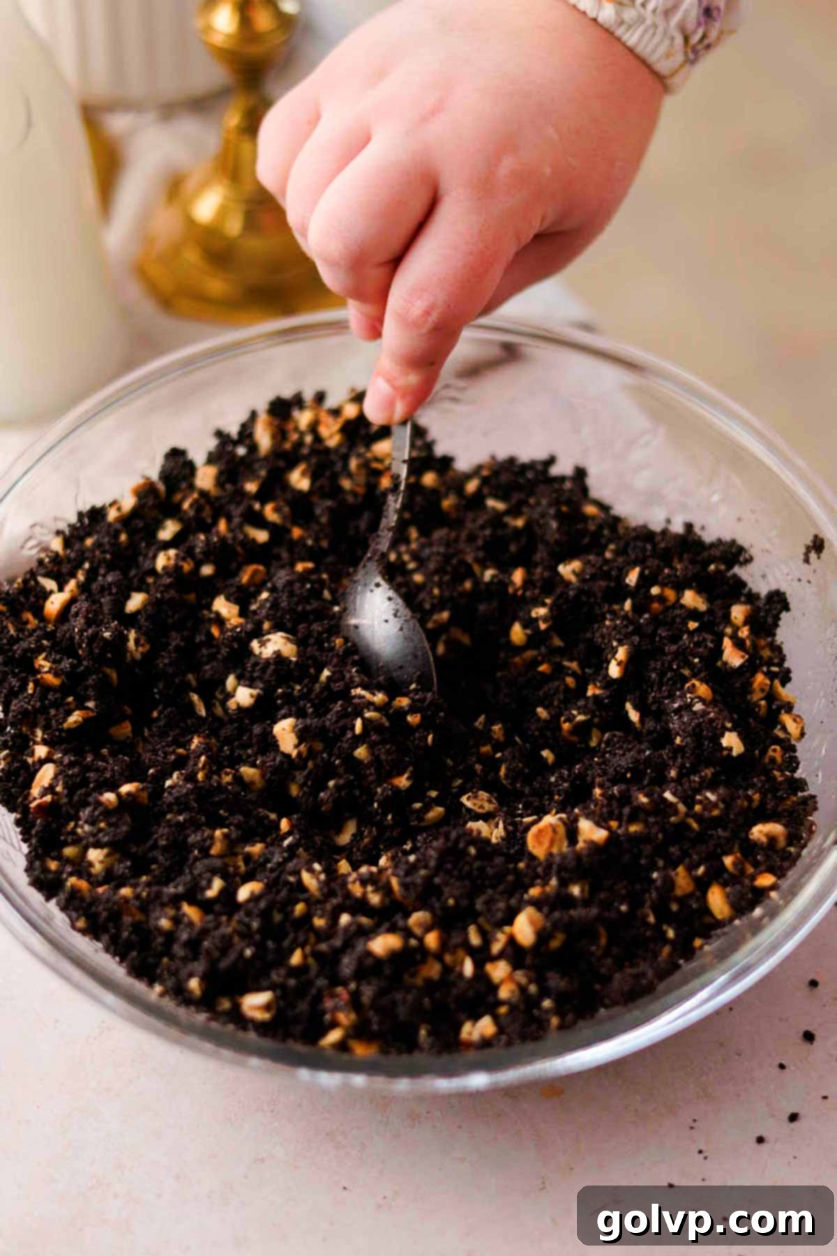 stirring together ingredients for chocolate hazelnut crust