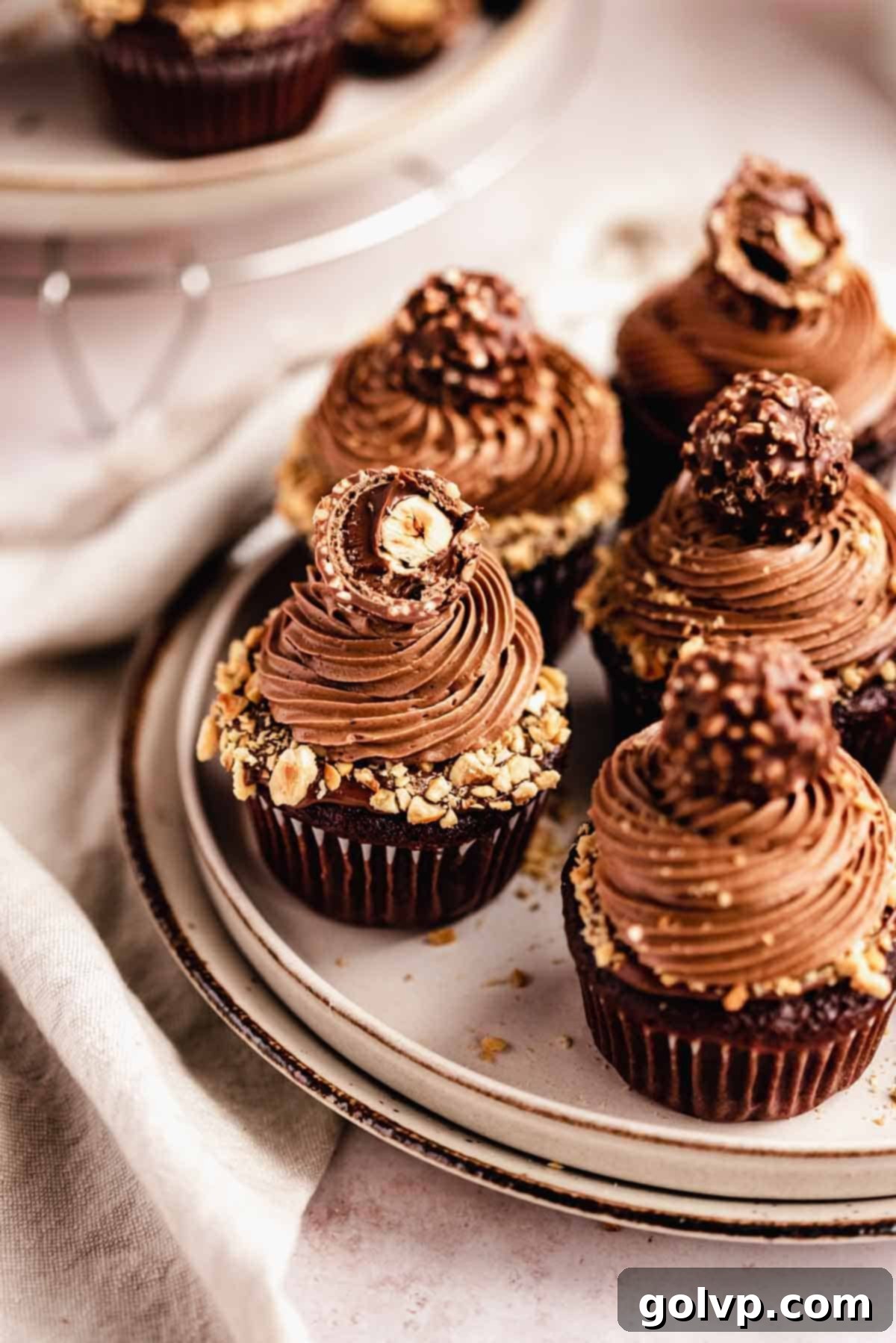chocolate cupcakes with nutella frosting topped with ferrero rocher chocolate