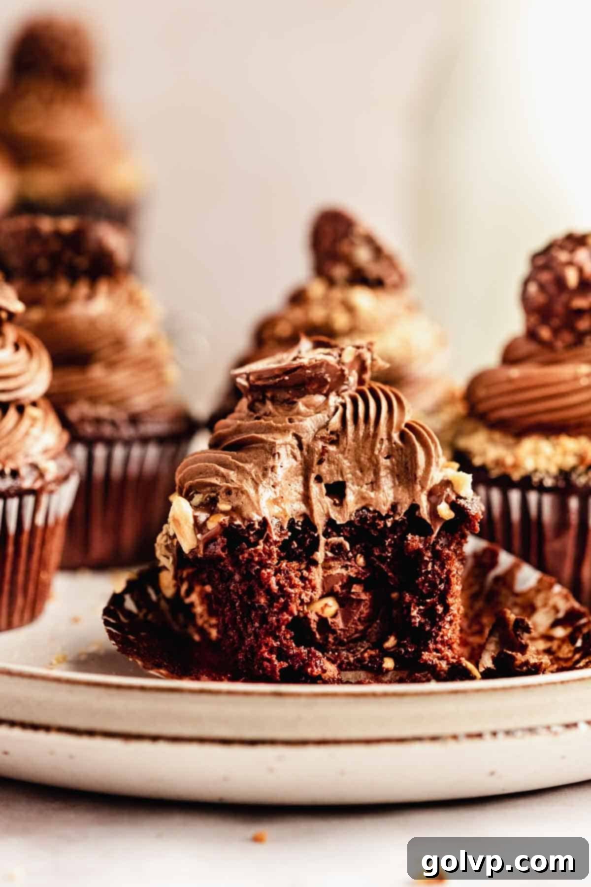 bitten chocolate cupcake stuffed with ferrero rocher and topped with creamy nutella buttercream