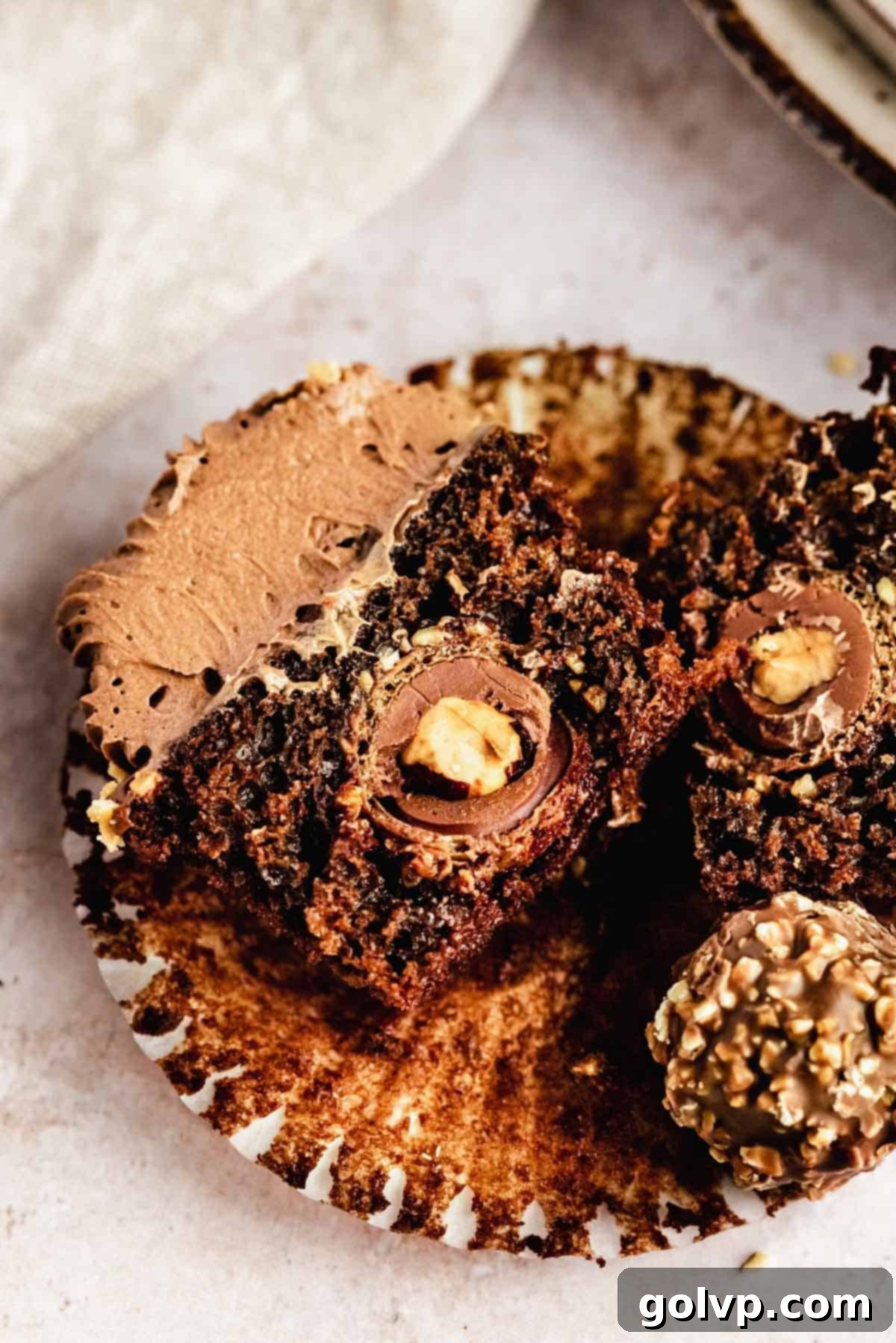 chocolate cupcake cut in half with ferrero rocher inside