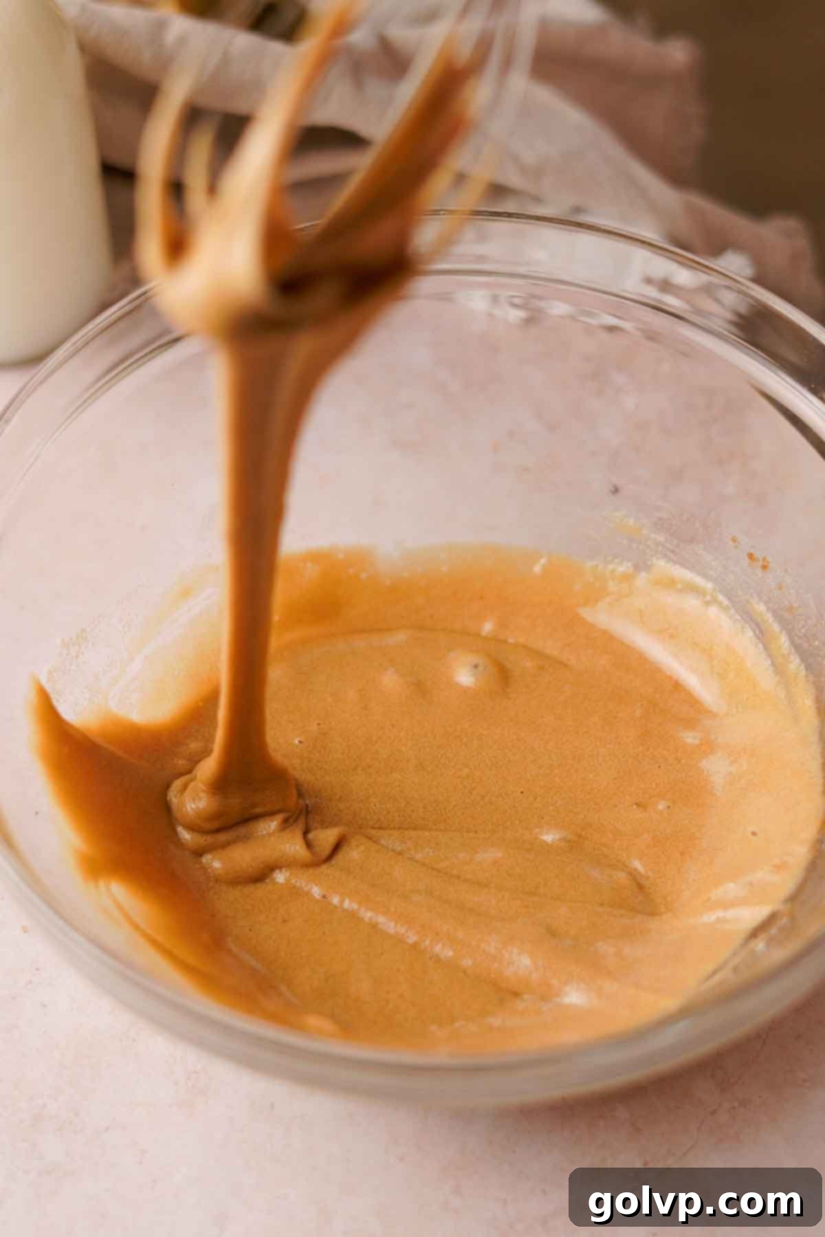 whisking egg, brown sugar, and granulated sugar with a wire whisk until caramel colored and thick
