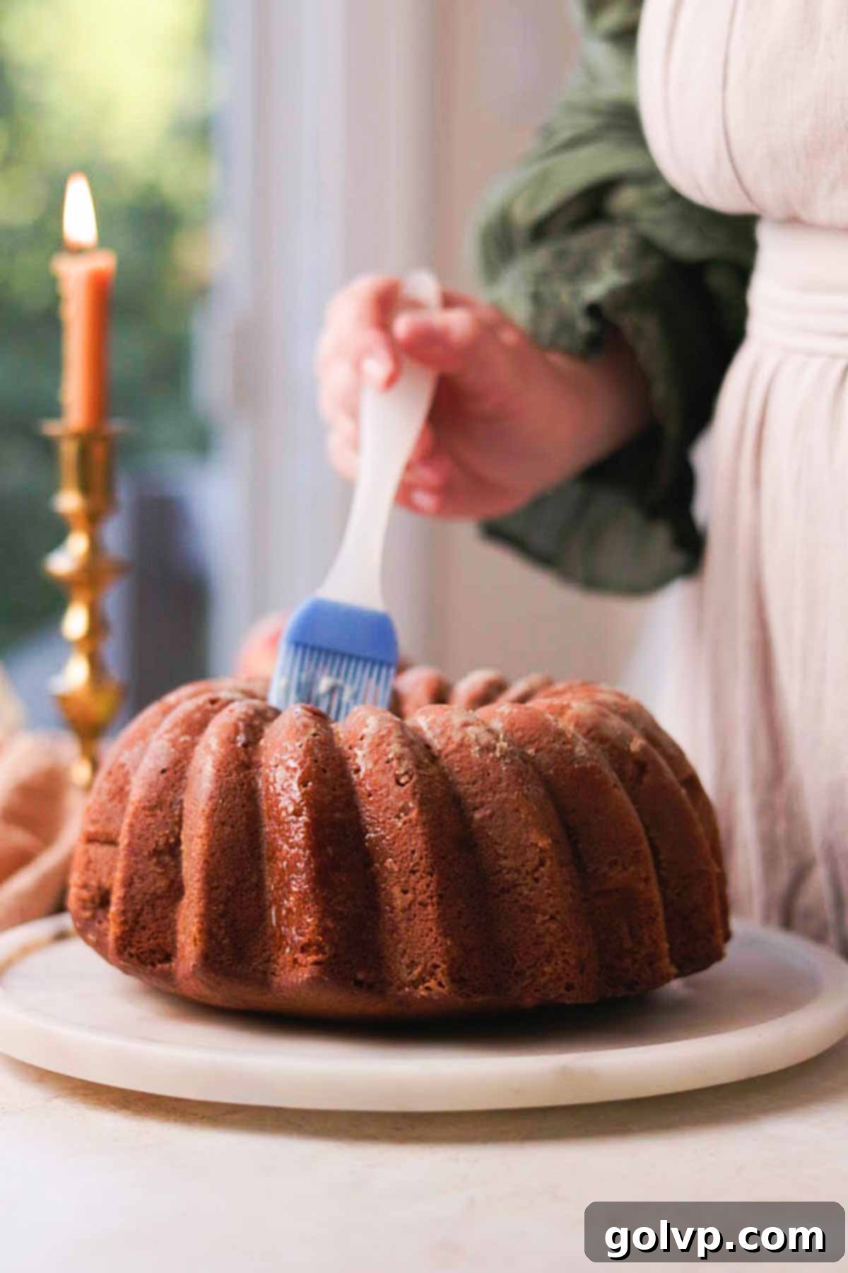 Spiced Autumn Apple Bundt 13 brushing bundt cake with butter