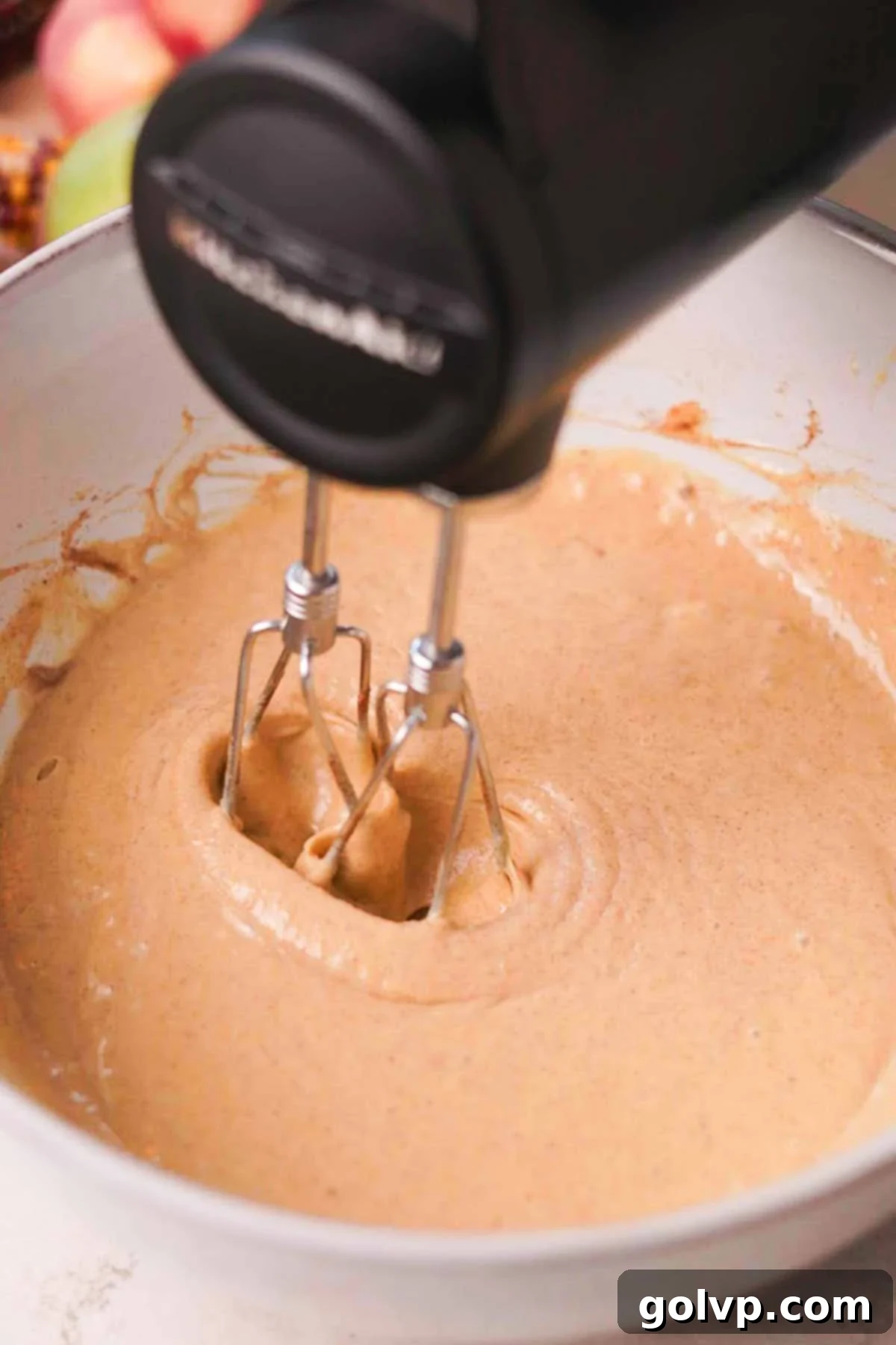 Spiced Autumn Apple Bundt 8 blending wet ingredients for apple cider bundt cake in a large bowl