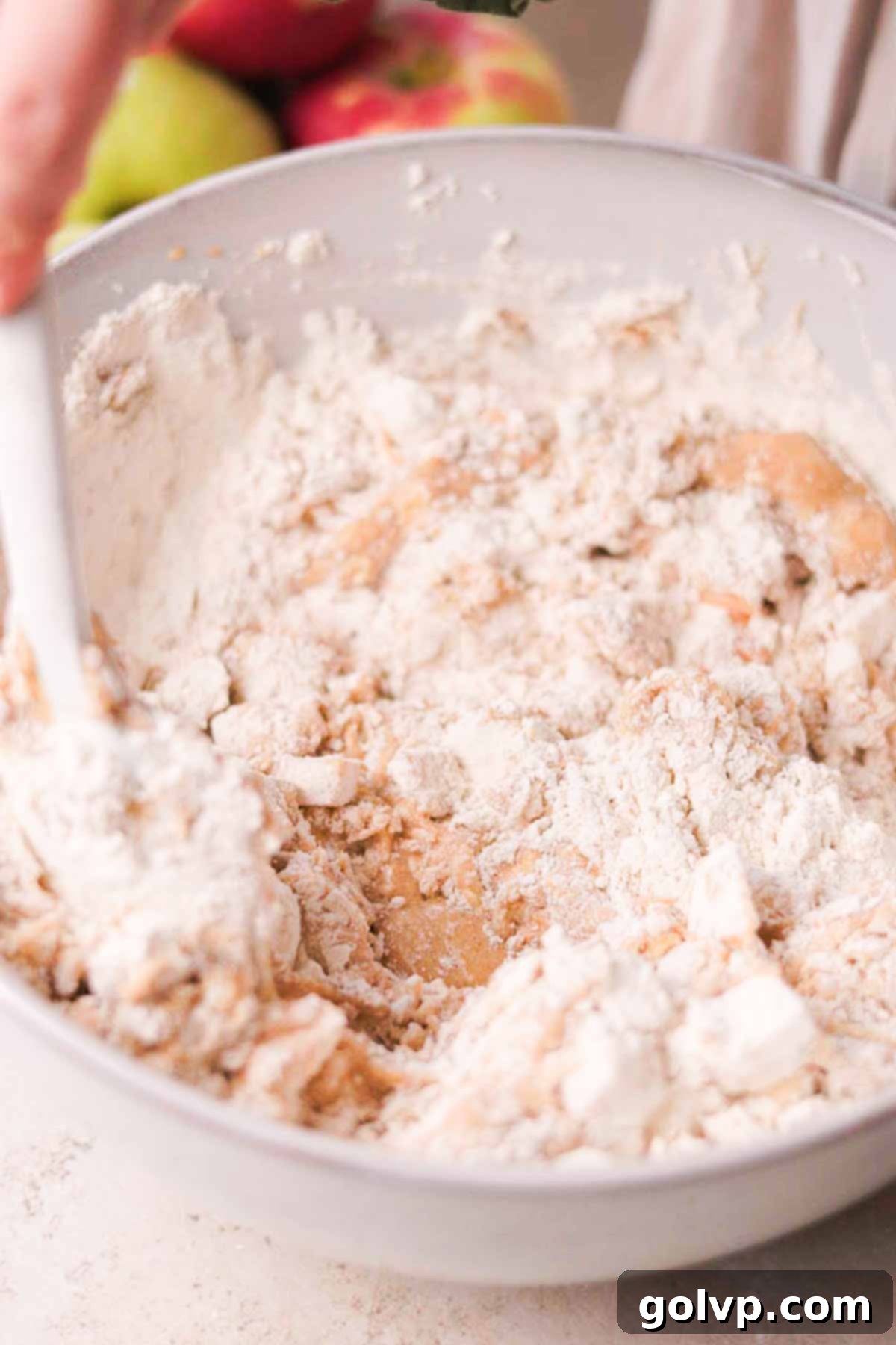 Spiced Autumn Apple Bundt 9 folding flour into the dry ingredients with a spatula