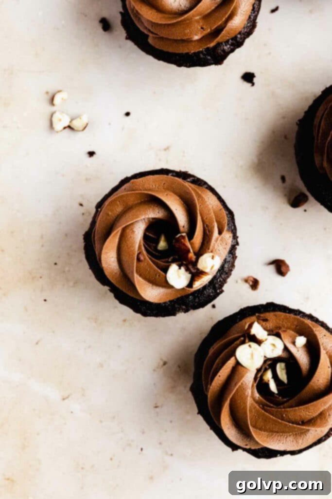 Frosted cupcakes with chocolate and hazelnut topping, a close-up.