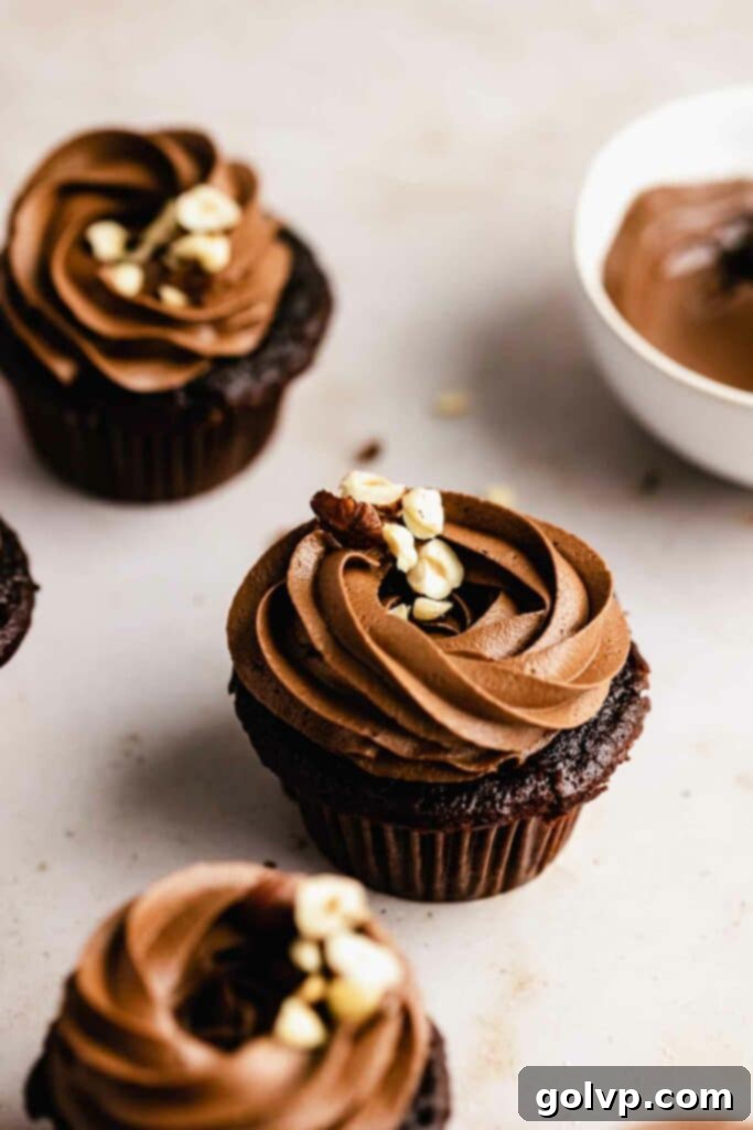Nutella cupcakes with chocolate Nutella buttercream, garnished with hazelnuts.