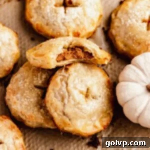 A perfectly bitten pumpkin hand pie, showcasing its flaky crust and rich filling