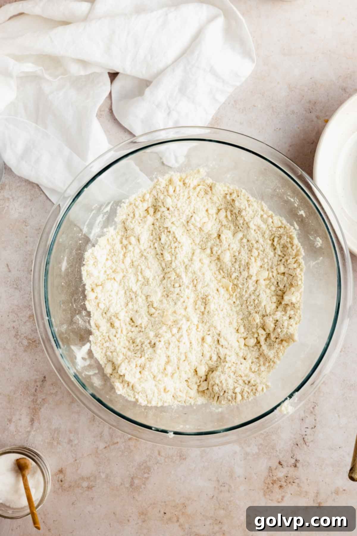 Flour and cubed frozen butter in a bowl, ready to be mixed for pie crust.