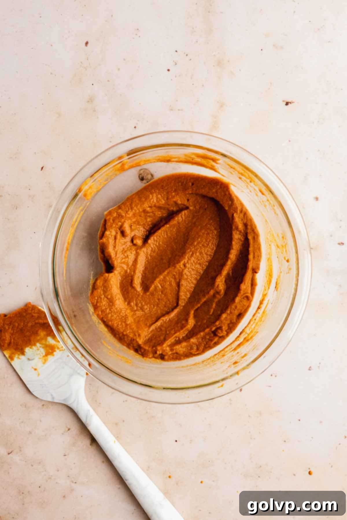 A bowl of creamy, smooth pumpkin pie filling ready for assembly.