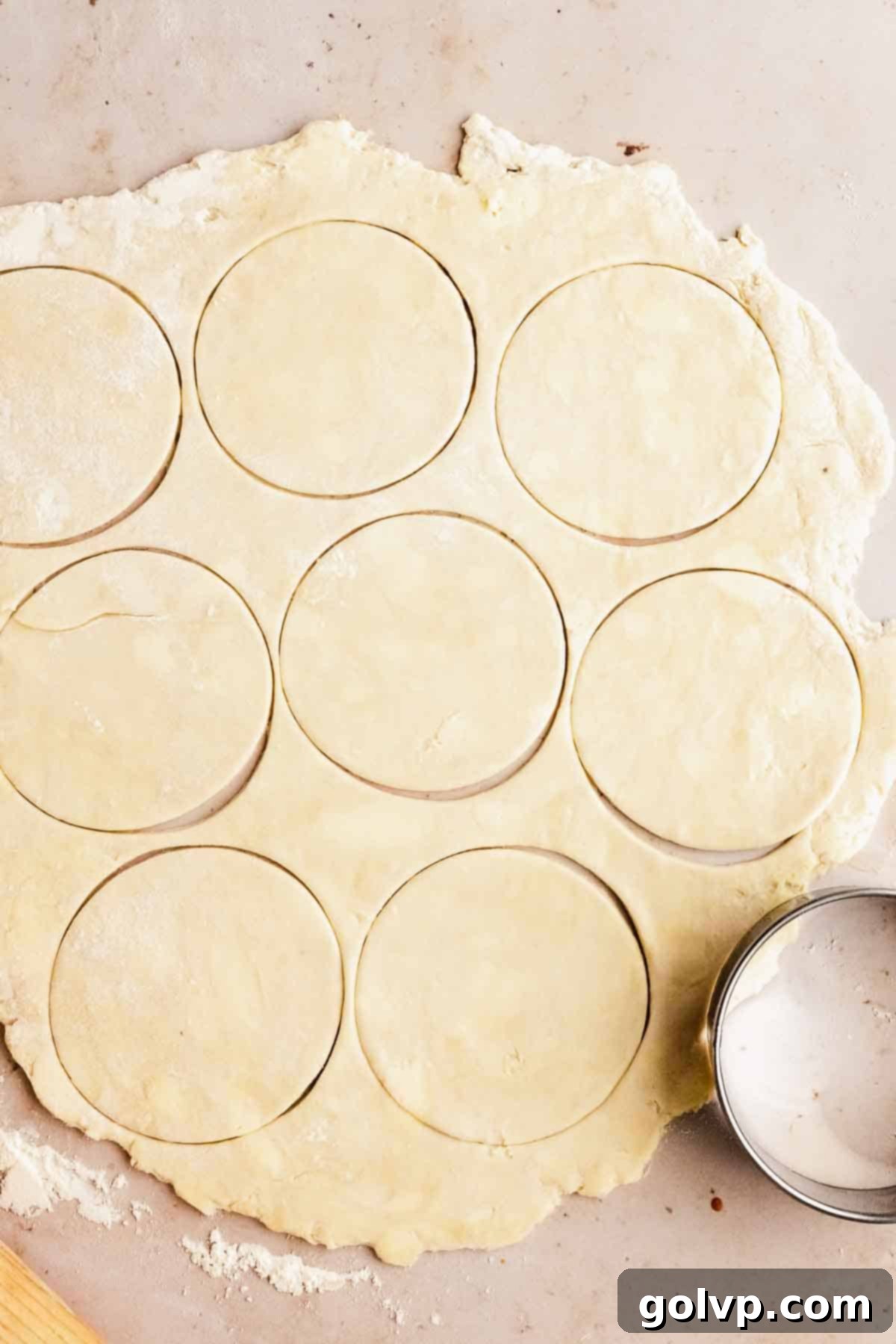 Cutting out perfect round pastry circles from rolled-out dough.