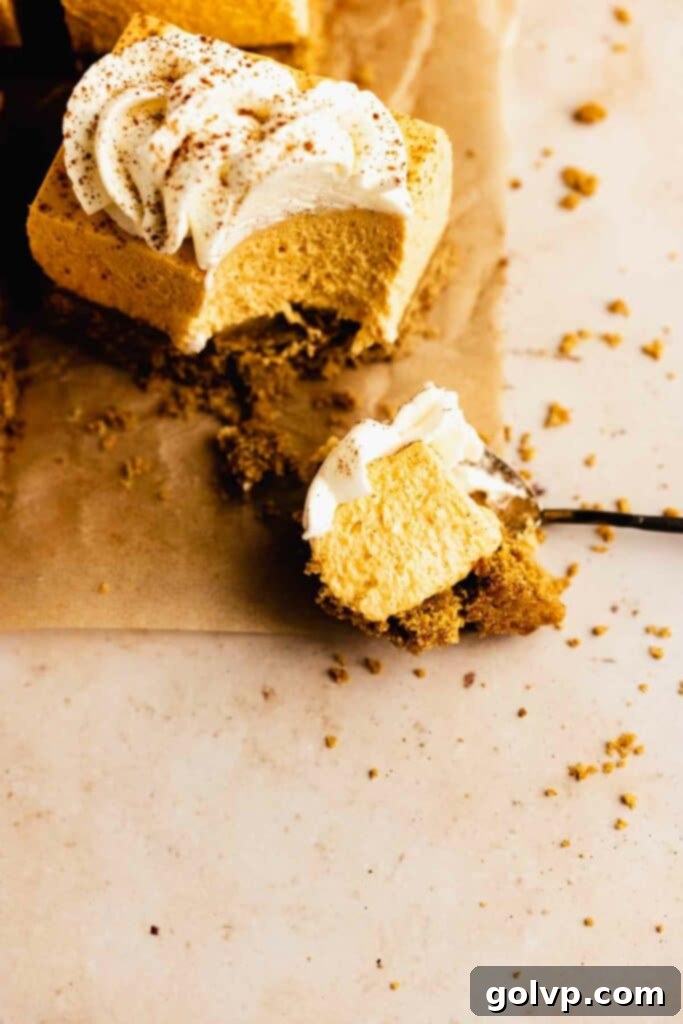 Easy No-Bake Pumpkin Cheesecake Bars 2 Taking a bite of a cheesecake slice