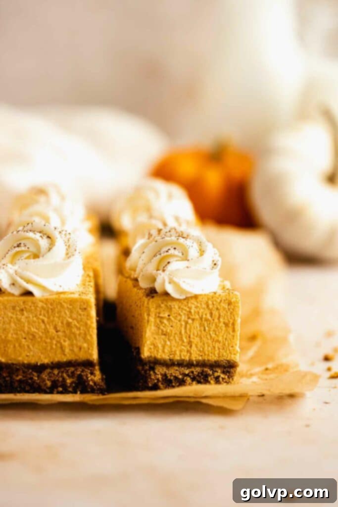 Easy No-Bake Pumpkin Cheesecake Bars 4 Pumpkin cheesecake bars on parchment paper