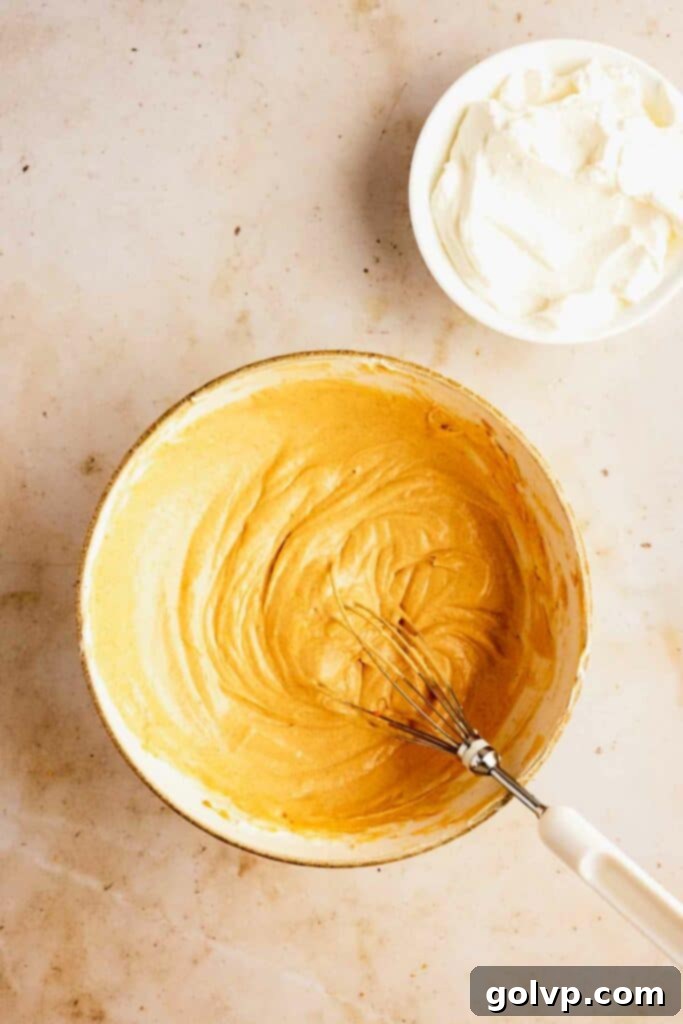 Easy No-Bake Pumpkin Cheesecake Bars 9 Adding pumpkin to cheesecake filling