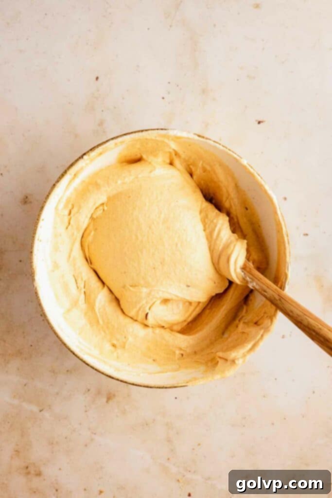 Easy No-Bake Pumpkin Cheesecake Bars 10 Folding cream into the batter