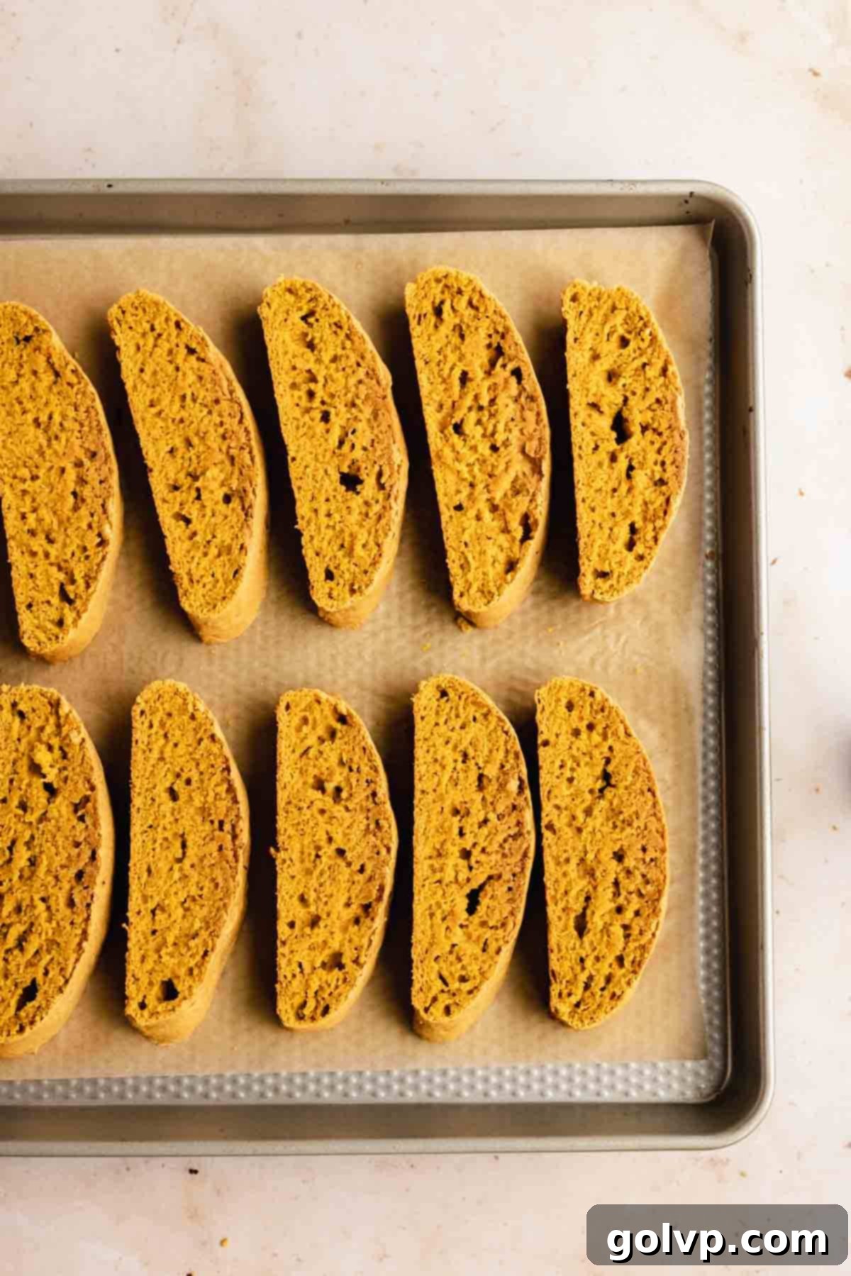 Autumn Pumpkin Biscotti 9 Individual biscotti slices arranged cut-side down on a baking sheet, ready for their second bake to achieve ultimate crispness.