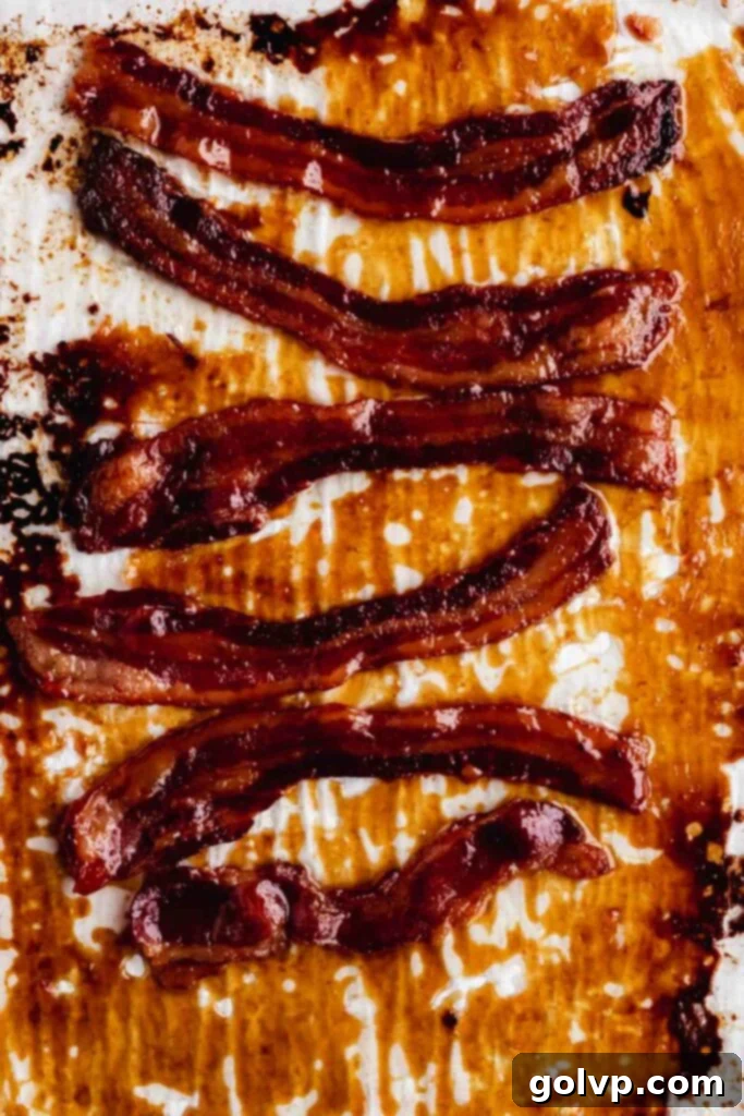 Close-up of freshly baked maple glazed candied bacon, crispy and golden brown, glistening with caramelized sugar.