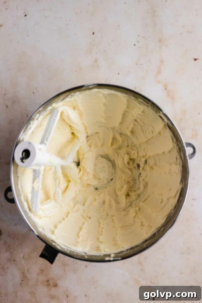 Beating butter and powdered sugar for the buttercream base