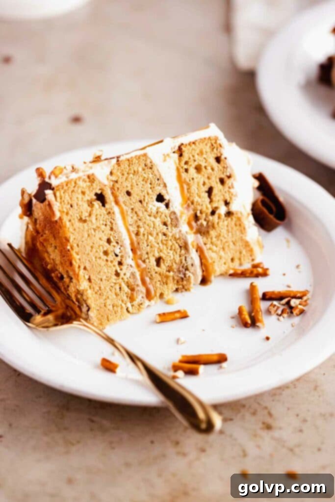 slice of butterscotch cake on plate showing layers and frosting