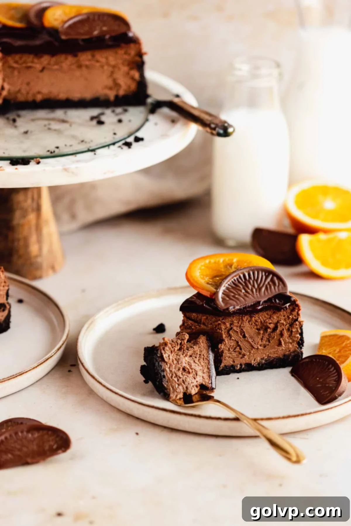 slice of chocolate orange cheesecake on a plate with a fork cut through it