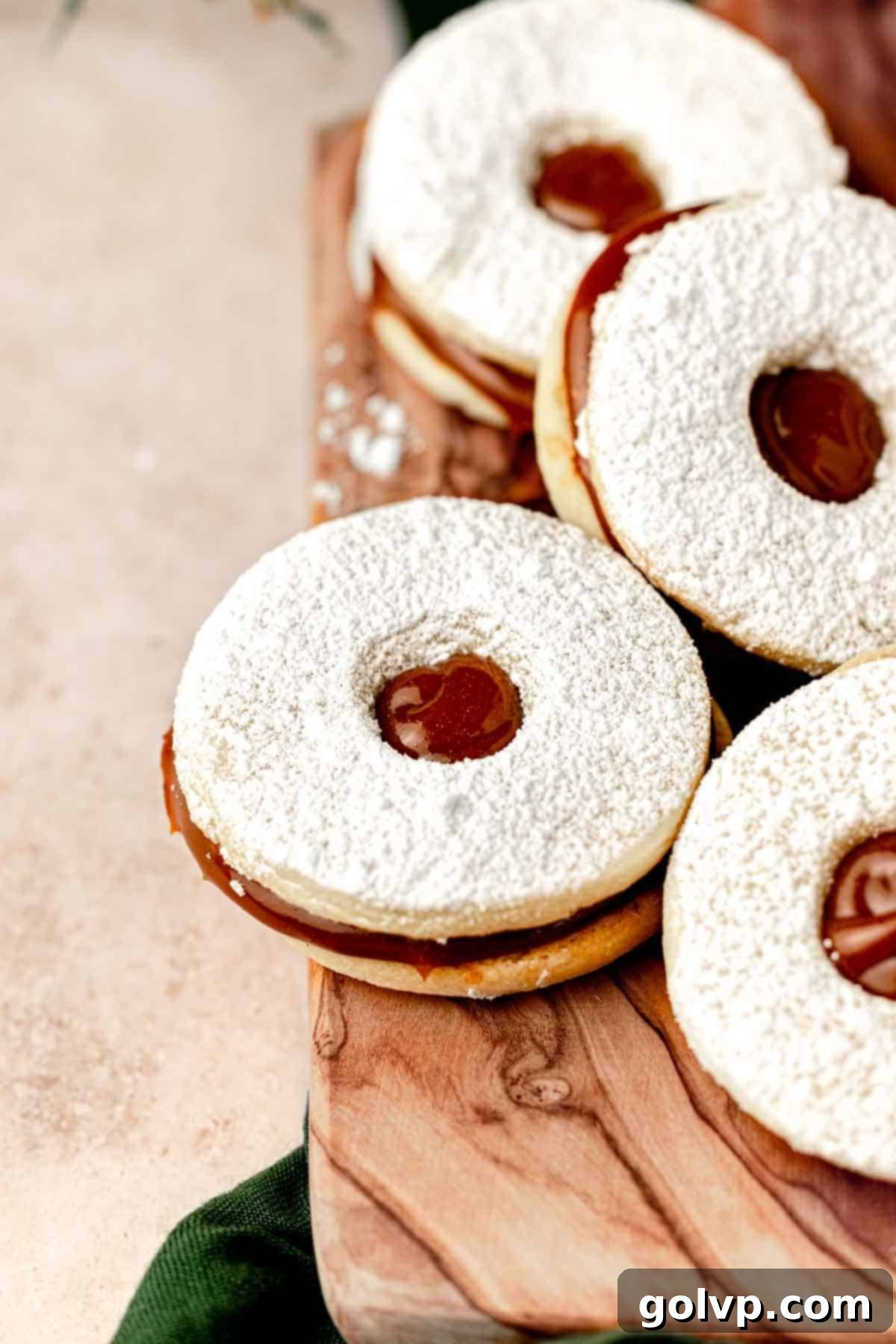 cookie sandwiched with dulce de leche on cutting board