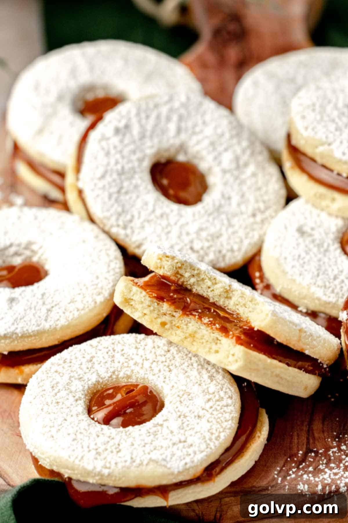 bitten dulce de leche filled cookies on cutting board