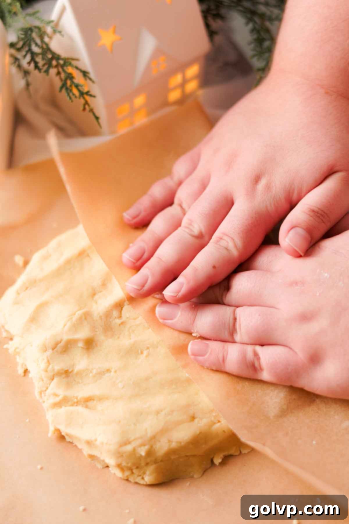 covering cookie dough with parchment paper to chill