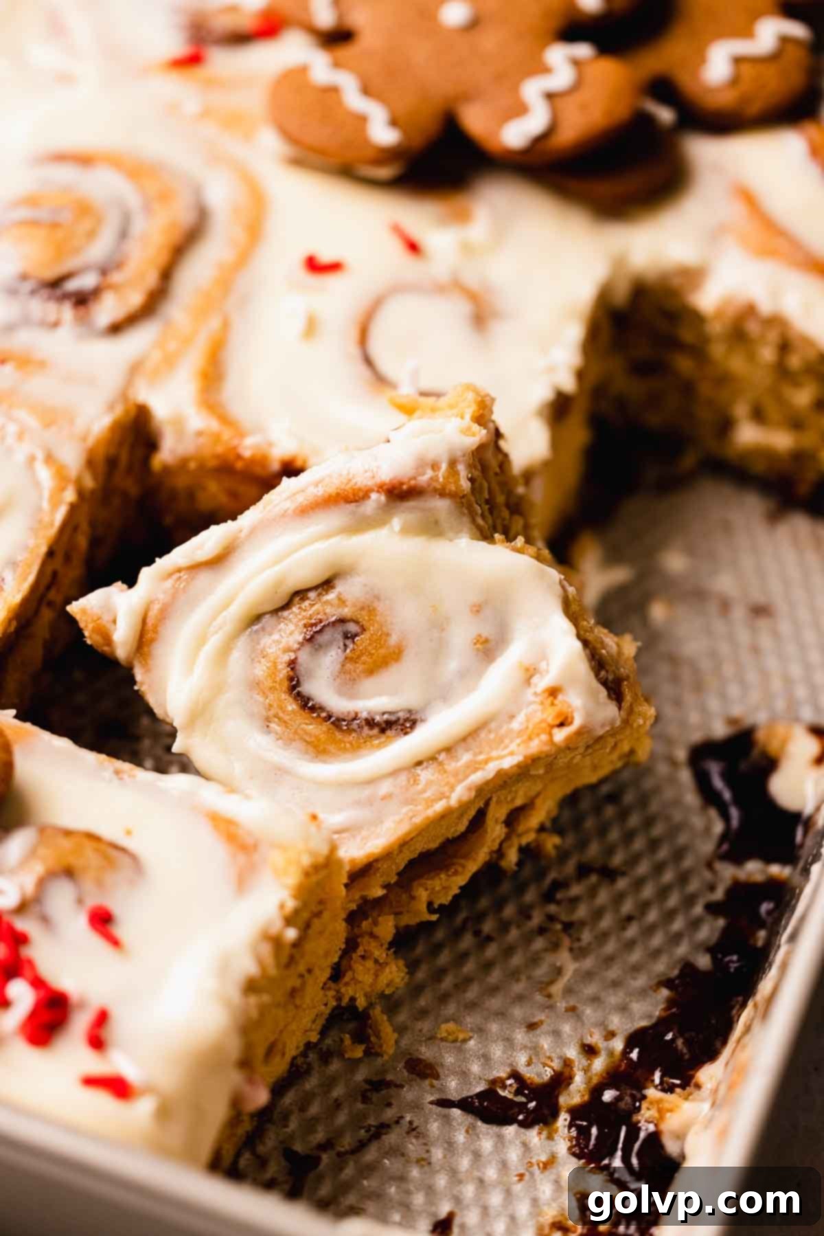 cut piece of gingerbread cinnamon roll with frosting