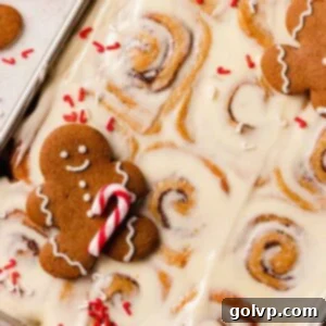 gingerbread cinnamon rolls with gingerbread cookies and candy cane sprinkles
