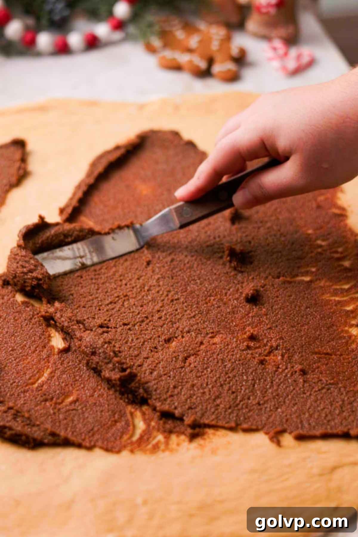spreading gingerbread filling on top of rolled out dough