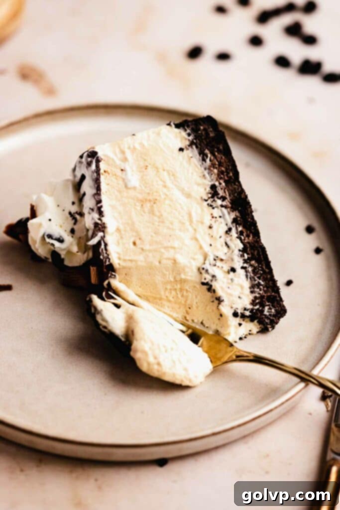 A hand taking a bite of creamy Baileys cheesecake with a fork